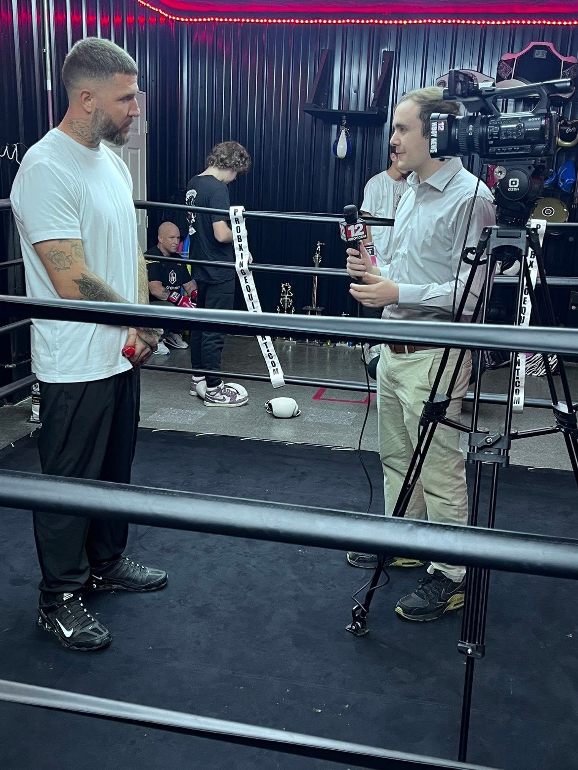 Coach Ronnie Hall being interviewed by WBOY News in the ring at Kings Hands