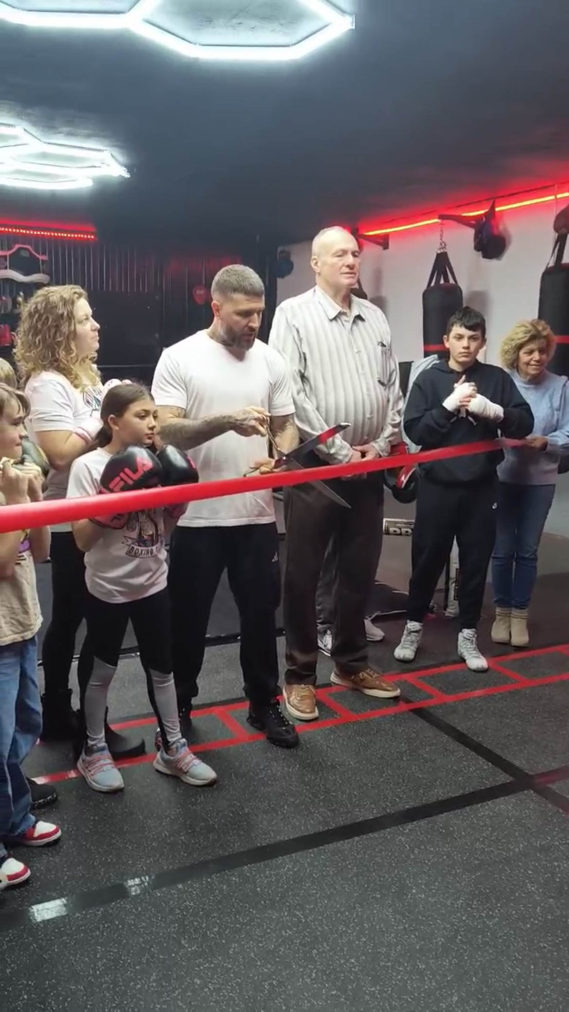 Coach Ronnie Hall cutting the ribbon with the Mayor of Stonewood at the gym's grand opening